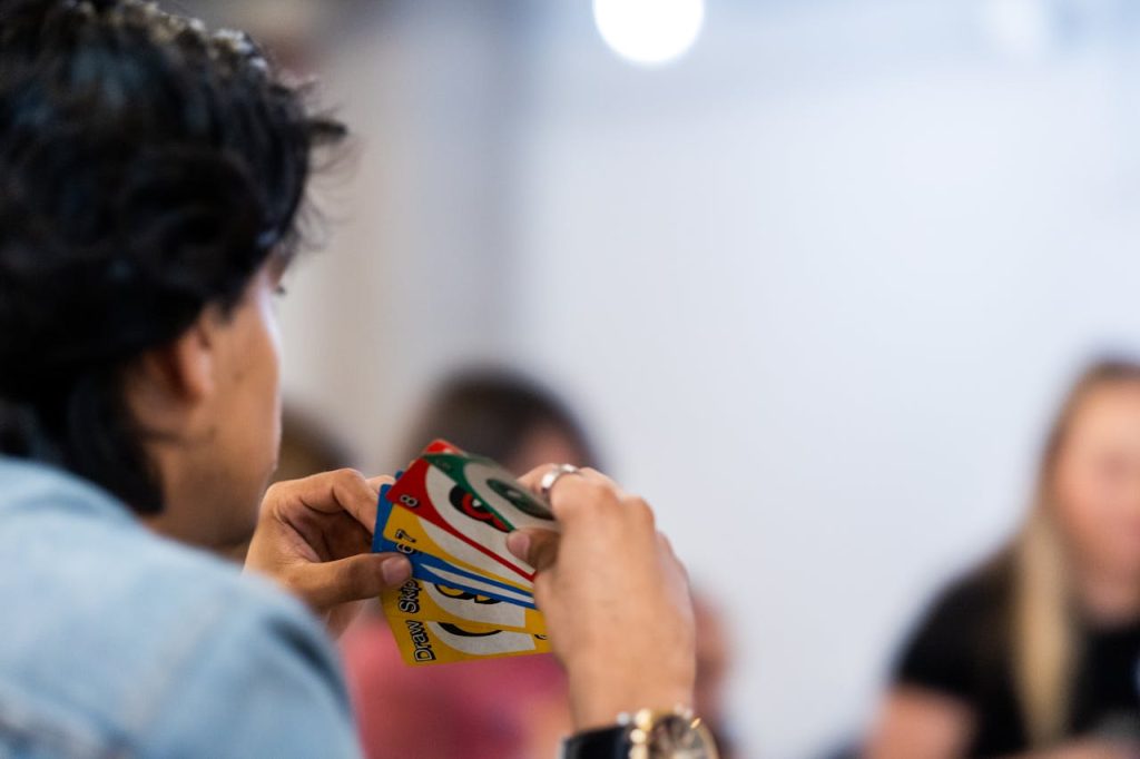 close-up-of-person-holding-colorful-card-game-34516198
